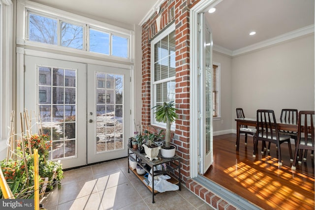 entryway featuring ornamental molding, light tile patterned floors, and french doors