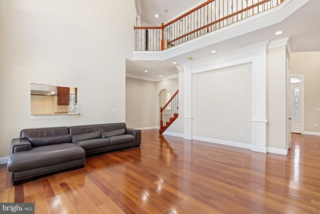 living room with wood-type flooring and ornate columns