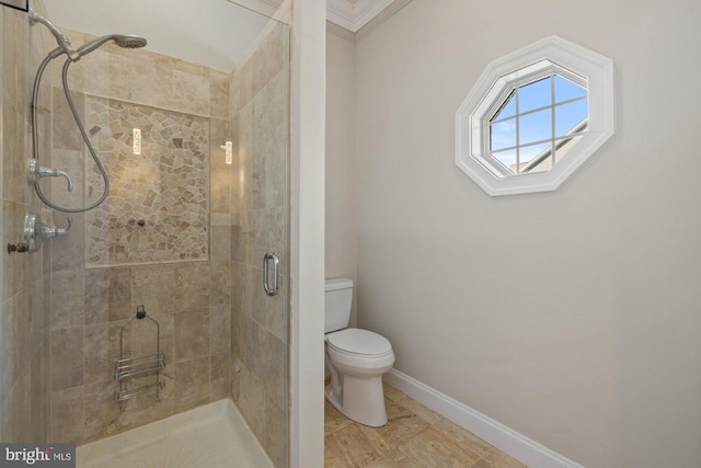 bathroom with ornamental molding, a shower with shower door, and toilet