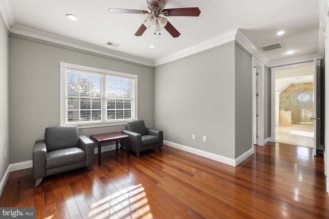 living area featuring ceiling fan, ornamental molding, and dark hardwood / wood-style floors