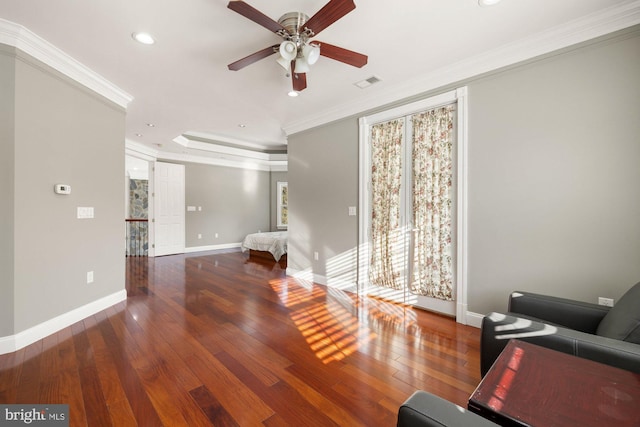 unfurnished living room featuring crown molding, ceiling fan, a tray ceiling, and hardwood / wood-style floors