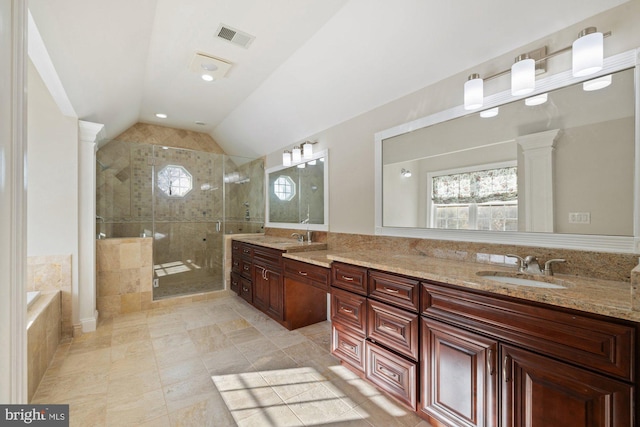 bathroom featuring decorative columns, vanity, lofted ceiling, and separate shower and tub