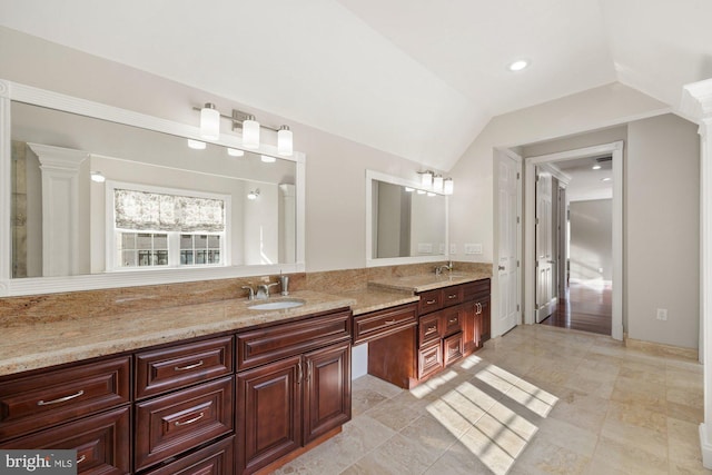 bathroom featuring vanity and lofted ceiling