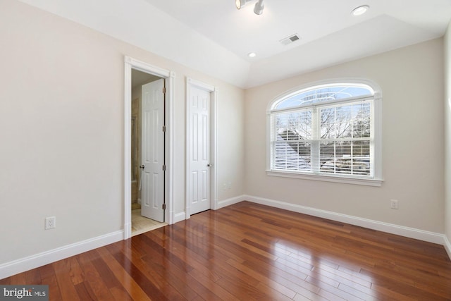 unfurnished bedroom with hardwood / wood-style flooring