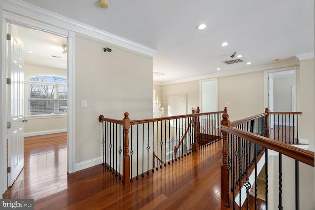 hallway with ornamental molding and dark hardwood / wood-style flooring