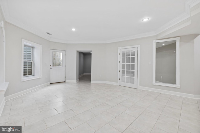 tiled empty room featuring crown molding