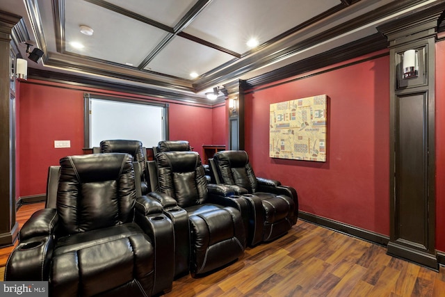 cinema room with dark hardwood / wood-style flooring and crown molding