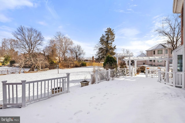 yard covered in snow with a pergola