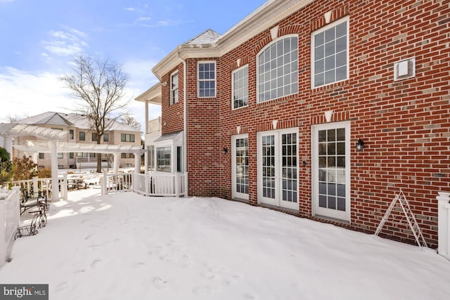 snow covered house with a pergola