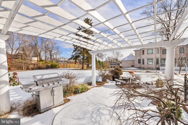 snow covered patio featuring a pergola and grilling area