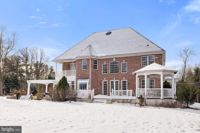 view of snow covered rear of property