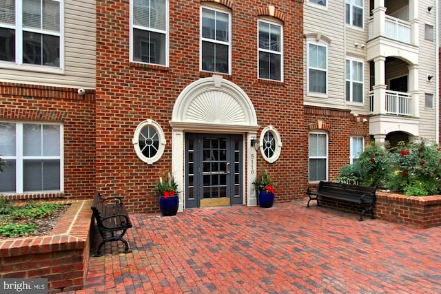 view of exterior entry featuring a patio area