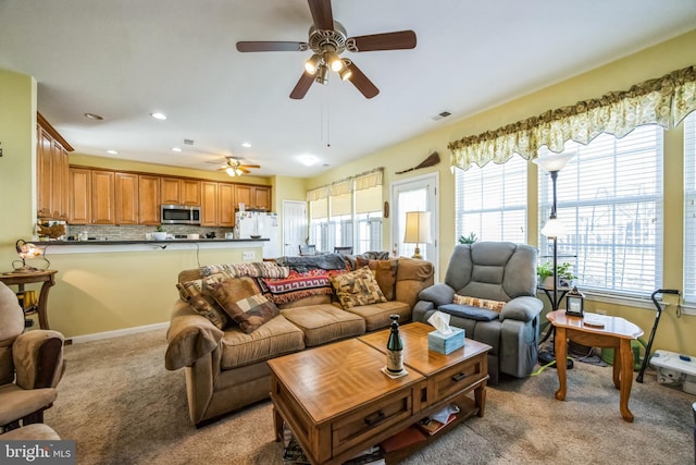 living room with recessed lighting, visible vents, and light colored carpet