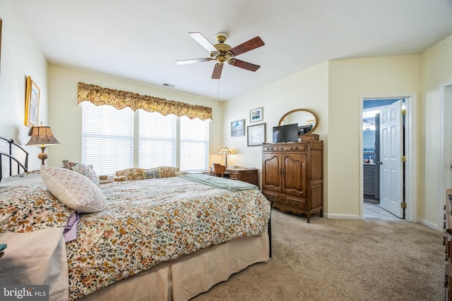 bedroom with visible vents, a ceiling fan, ensuite bathroom, carpet flooring, and baseboards