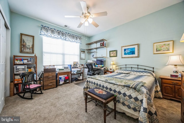 carpeted bedroom with a ceiling fan, visible vents, and a closet