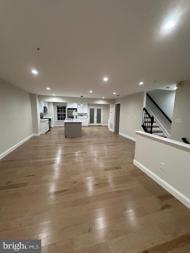 unfurnished living room with hardwood / wood-style flooring