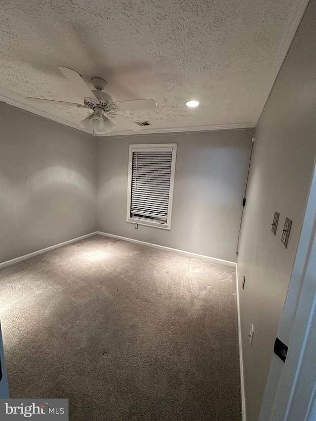 unfurnished room featuring crown molding, a textured ceiling, ceiling fan, and carpet