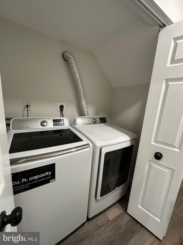 washroom with separate washer and dryer and dark hardwood / wood-style floors