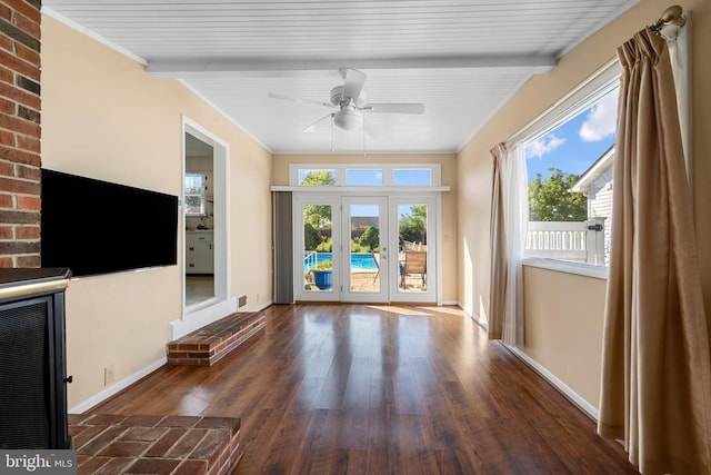 unfurnished living room with french doors, ceiling fan, beam ceiling, and dark wood-type flooring