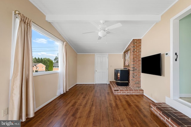 unfurnished living room featuring beamed ceiling, a wood stove, dark wood-type flooring, and ceiling fan