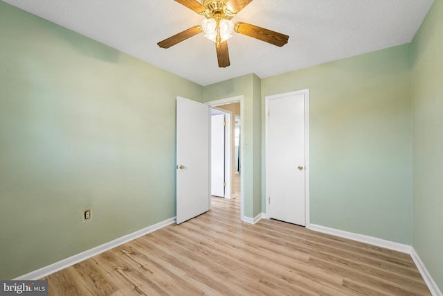 unfurnished bedroom with ceiling fan and light hardwood / wood-style floors