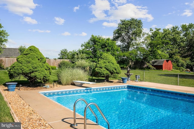 view of pool featuring a diving board