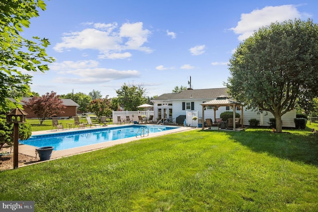 view of swimming pool with a gazebo and a lawn