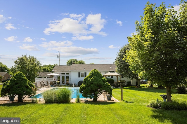 rear view of house with a yard, a gazebo, and a patio area