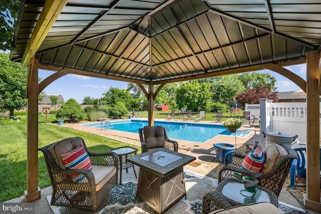 view of swimming pool featuring a gazebo, a lawn, a patio area, and an outdoor fire pit