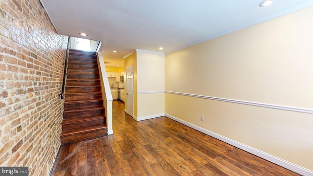 interior space with ornamental molding and hardwood / wood-style floors