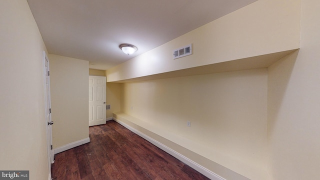 basement with dark hardwood / wood-style flooring