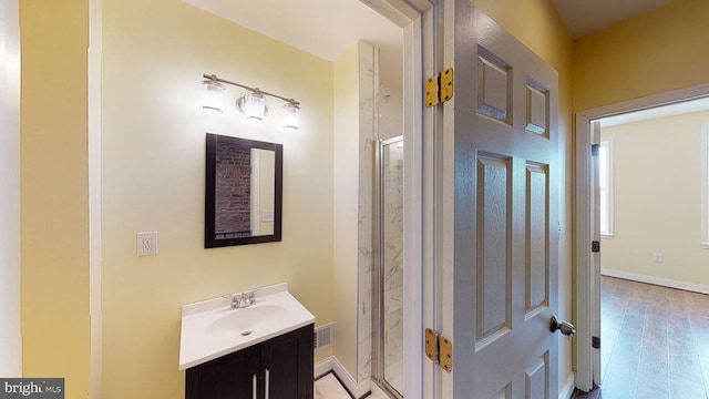 bathroom featuring vanity, a shower with shower door, and hardwood / wood-style flooring