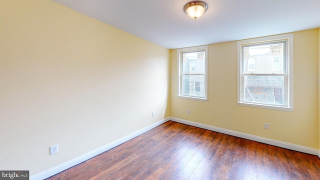 empty room featuring dark wood-type flooring