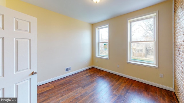 spare room with dark hardwood / wood-style floors