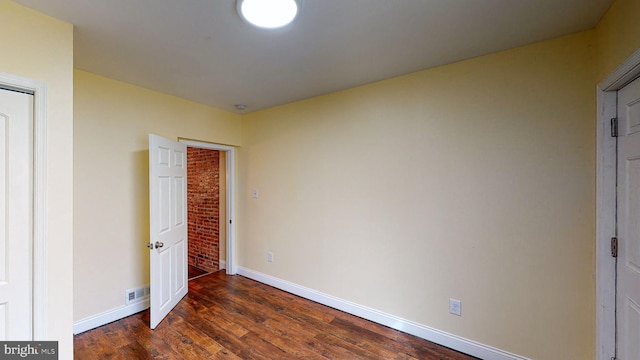 unfurnished bedroom featuring dark hardwood / wood-style flooring