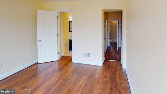 unfurnished bedroom featuring dark wood-type flooring