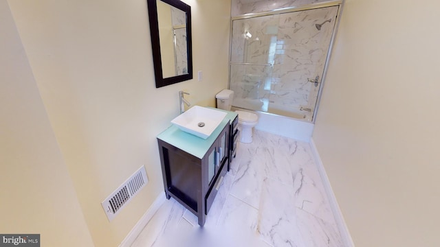 full bathroom with combined bath / shower with glass door, vanity, and toilet