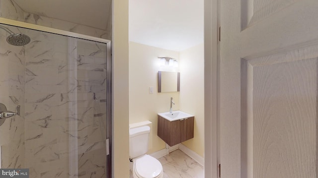 bathroom with vanity, a shower with shower door, and toilet