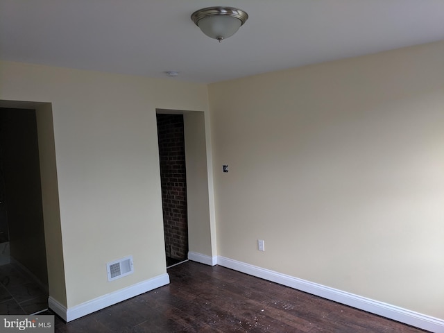 spare room with dark hardwood / wood-style floors