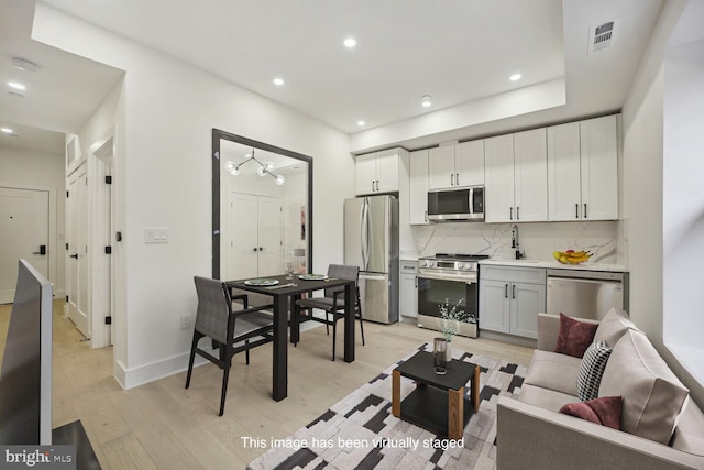 living room featuring light wood-type flooring and sink