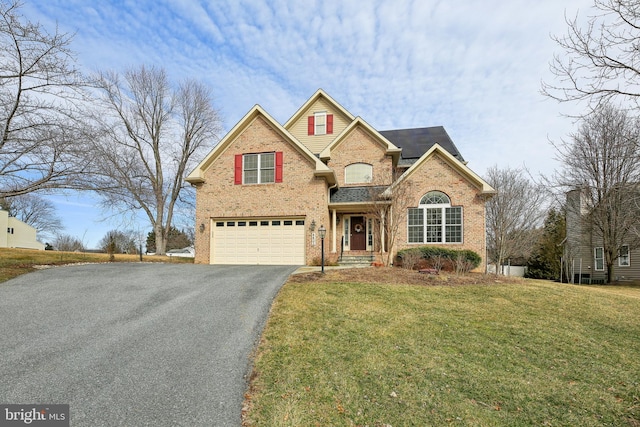 traditional-style home featuring aphalt driveway, a front yard, brick siding, and an attached garage