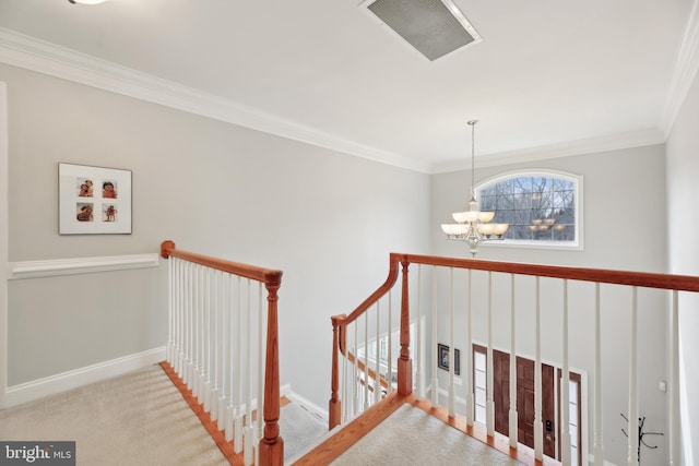 staircase featuring carpet floors, a notable chandelier, visible vents, ornamental molding, and baseboards