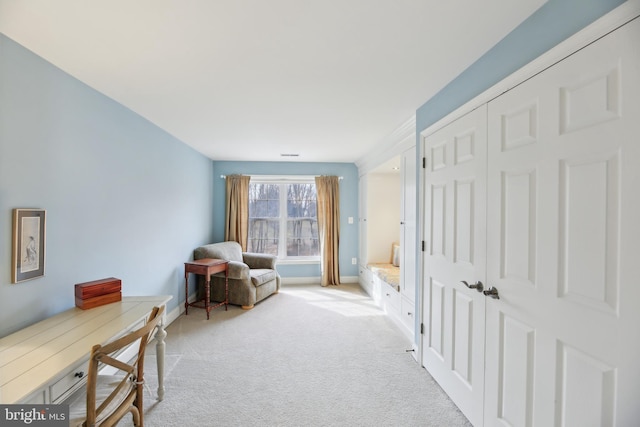 sitting room featuring light carpet, visible vents, and baseboards