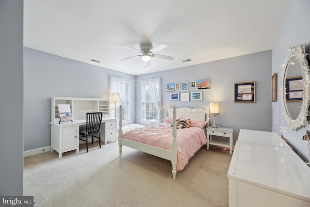 bedroom with a ceiling fan, light colored carpet, visible vents, and baseboards