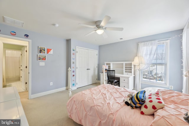 bedroom featuring a closet, visible vents, light carpet, ceiling fan, and baseboards