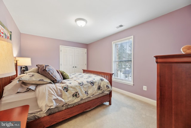 bedroom featuring carpet, a closet, visible vents, and baseboards