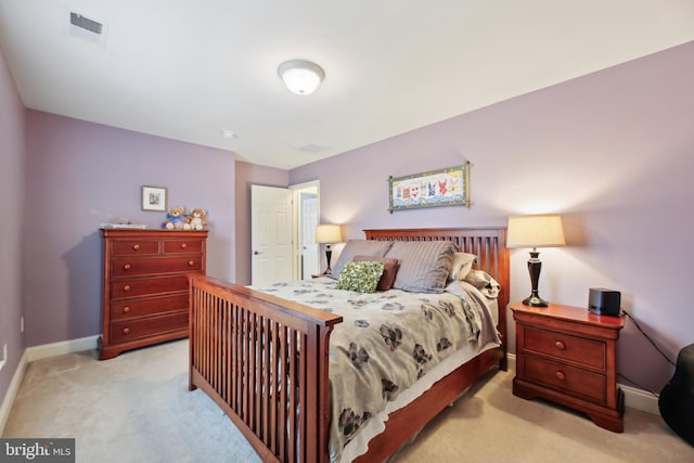 bedroom featuring light carpet, visible vents, and baseboards