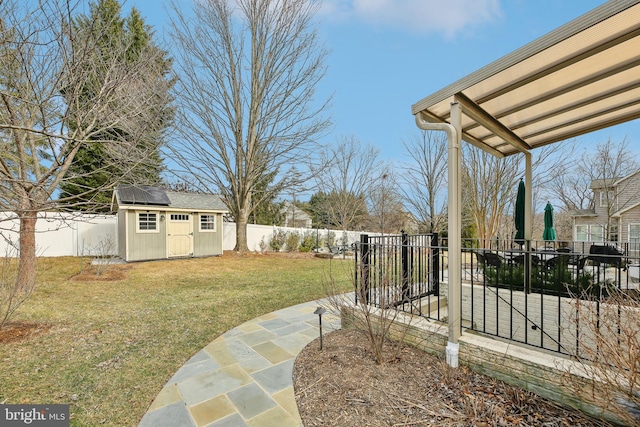 view of yard featuring a fenced backyard, an outdoor structure, and a storage shed