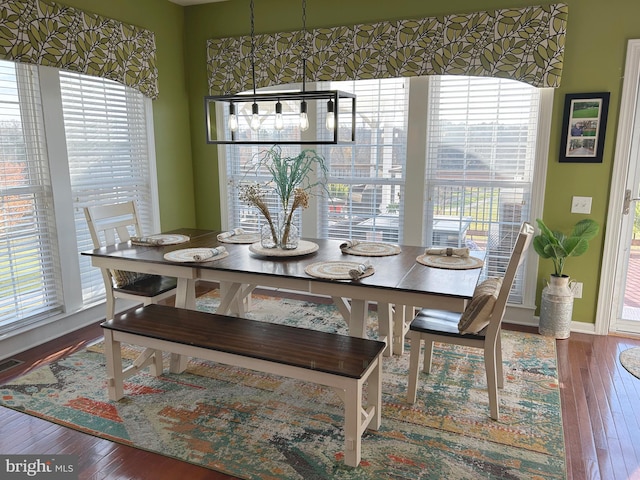 dining room with hardwood / wood-style flooring and plenty of natural light