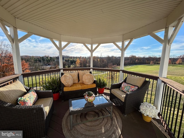 wooden deck with a yard and outdoor lounge area